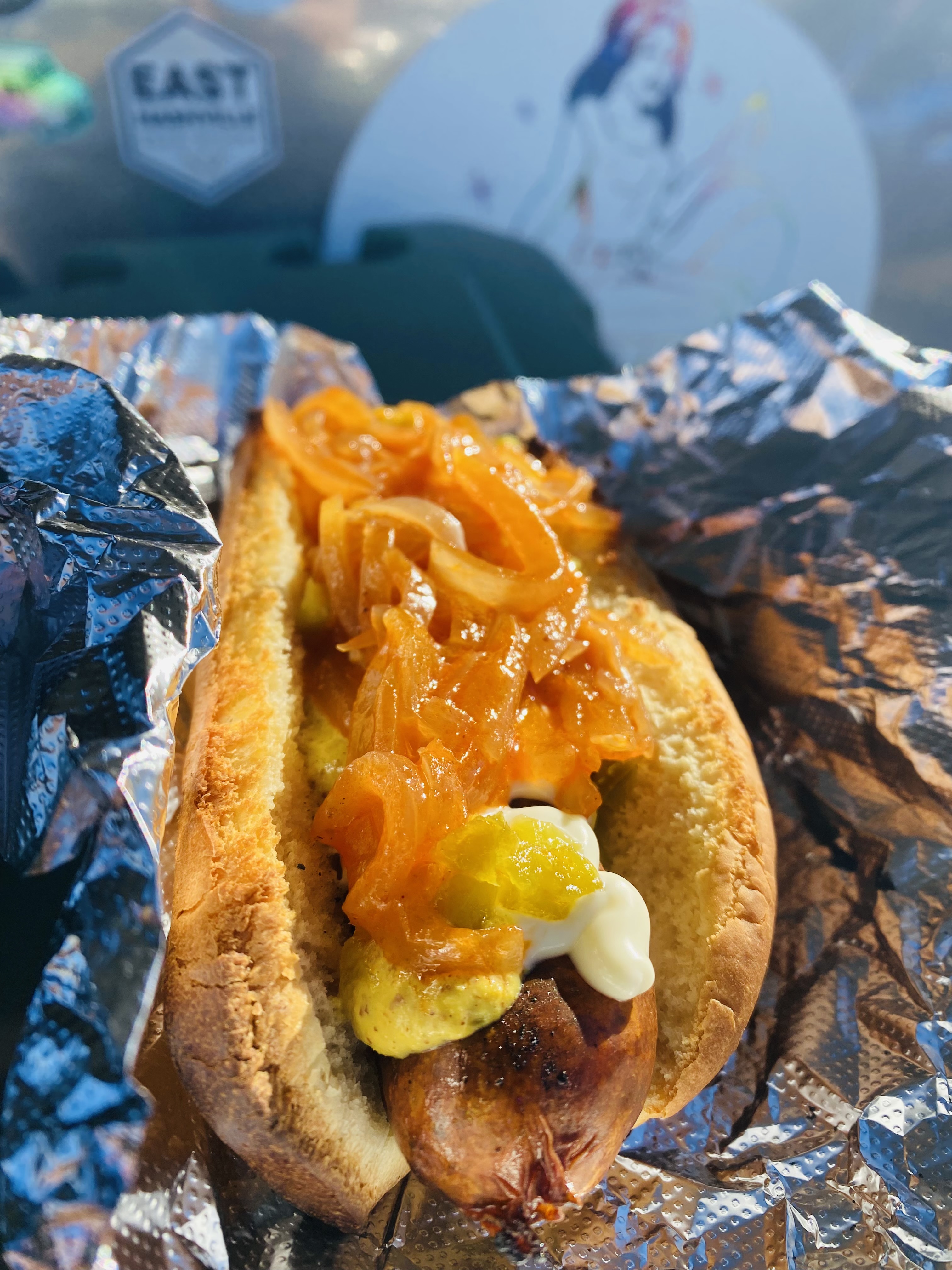 A loaded LadyDawgs hot dog with caramelized onions at an East Nashville event